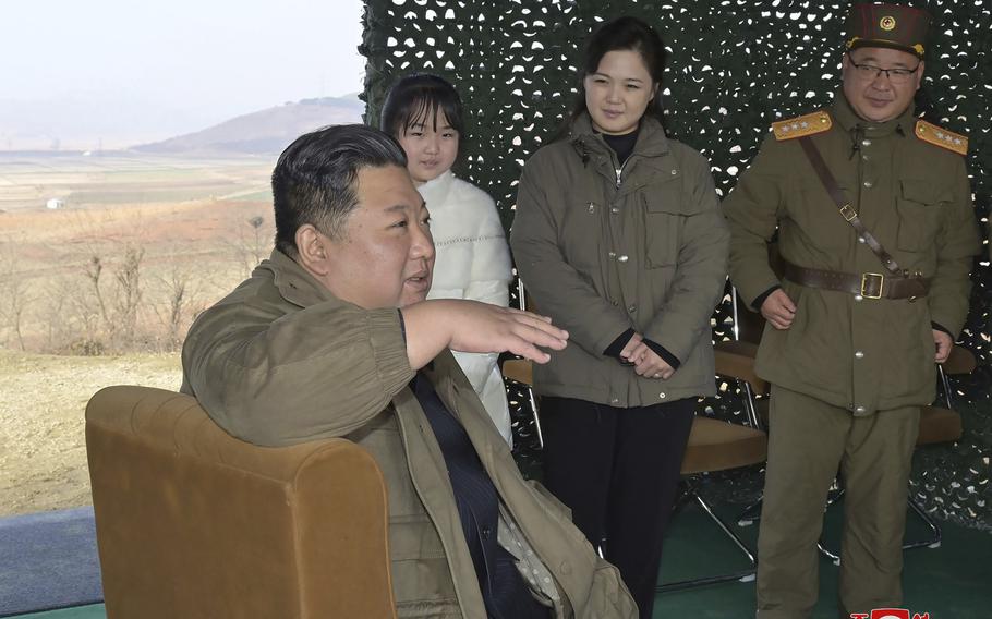 This photo provided on Nov. 19, 2022, by the North Korean government shows its leader Kim Jong Un, front, speaks, accompanied by his wife Ri Sol Ju, second from right, and his daughter, as Kim inspects  the test firing of what it says a Hwasong-17 intercontinental ballistic missile, at Pyongyang International Airport in Pyongyang, North Korea, Friday, Nov. 18, 2022.