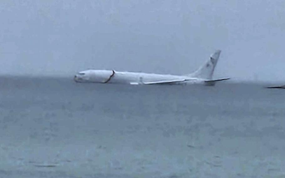 This photo provided by Diane Dircks shows a U.S. Navy plane that overshot a Marine base on Kaneohe Bay, Hawaii, Monday, Nov. 20, 2023. An official said all nine people aboard the plane have escaped injury.