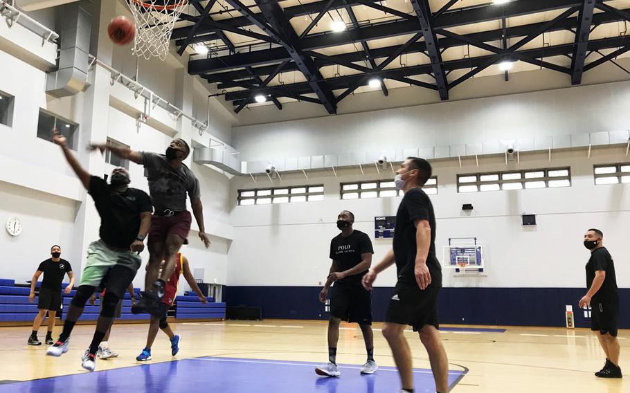 Basketball players mask up inside the North Gym at Marine Corps Air Station Iwakuni, Japan, Tuesday, Jan. 11, 2022.