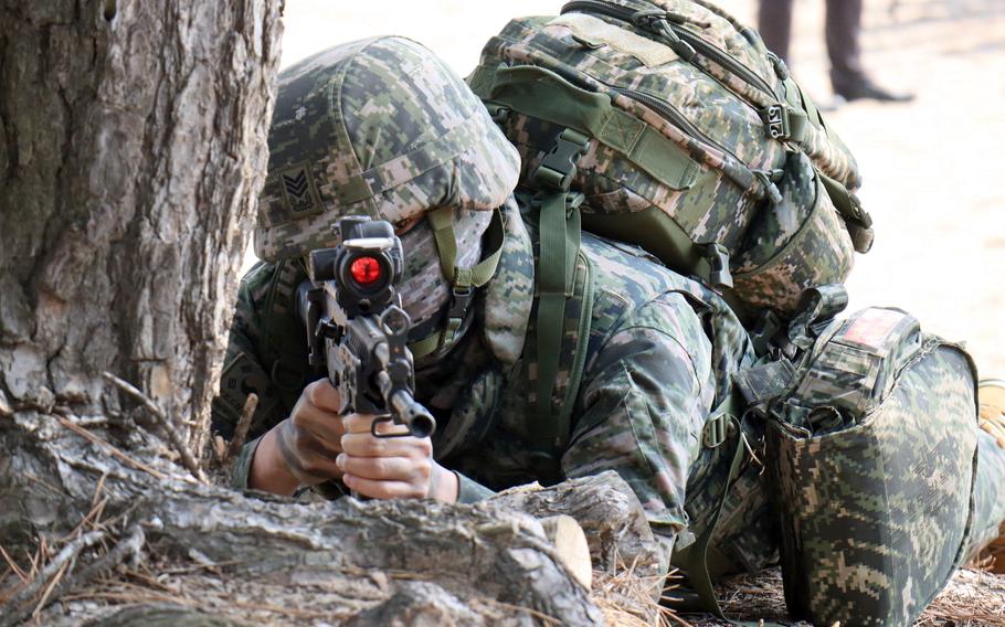 A South Korean marine takes aim with his rifle during training with U.S. Marines in Pohang, South Korea, March 29, 2023.