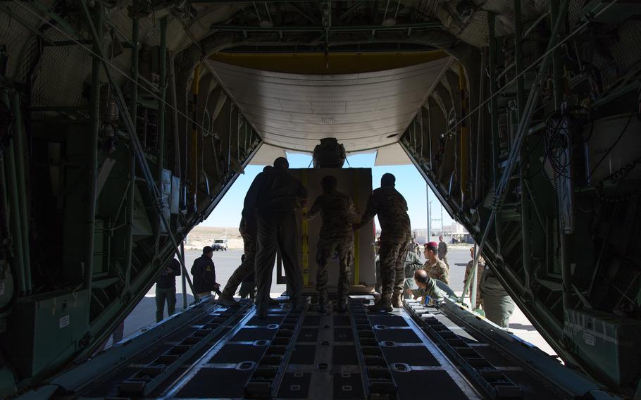 Jordanian Air Force members ensure the container is correctly positioned on the track for an efficient unloading process. King Abdullah II Air Base, Al Ghabawi, Jordan. 