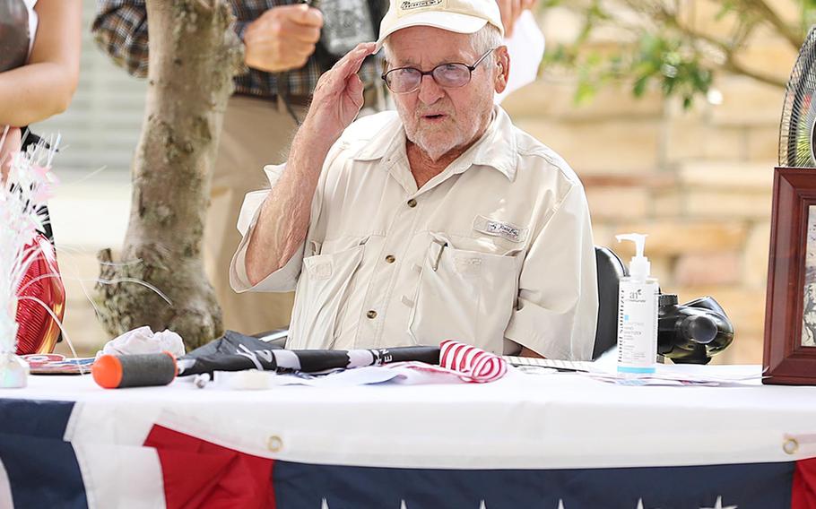 John Bellefontaine salutes as cars drive by his home in Leesburg, Fla., on Sept. 6, 2020. Bellefontaine, one of the last surviving members of 551st Parachute Infantry Division, died last month at 98.