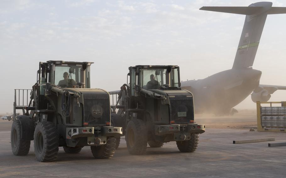 Airmen wait to offload cargo from a C-17 Globemaster III at Base 201 in Niger on April 26, 2023. The more than 1,000 American service members in Niger will stay for the time being following an attempted coup, the Defense Department said.