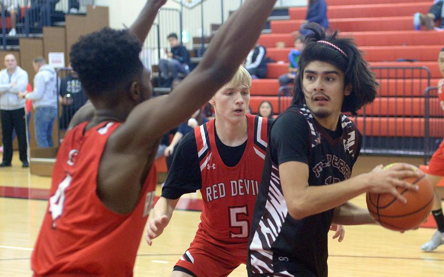 Matthew C. Perry's Daniel Rodriguez looks to pass against Nile C. Kinnick's Kennedy Hamilton and Gregor Tolar during Saturday's Japan boys basketball game. The Samurai won 79-67.