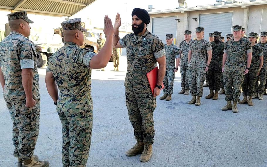 Capt. Sukhbir Singh Toor, an active duty artillery officer seen here at his pinning ceremony in March 2022, is suing the Marine Corps, saying policy that prohibits him and other Sikhs from wearing beards or keeping their hair long in combat zones and boot camp is discriminatory. 