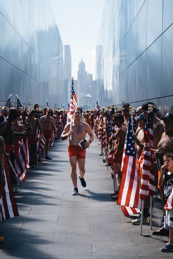 The final stretch of the NYC SEAL Swim sees athletes carry an American flag from Battery Park to One World Trade Center.