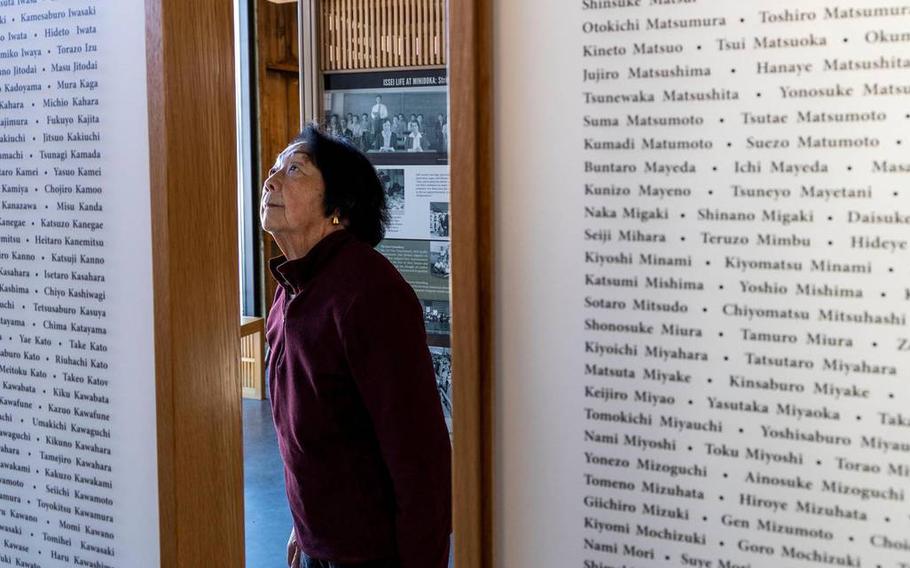 Karen Hirai Olen scans for familiar names on the Issei Memorial exhibit at Minidoka National Historic Site on Jan. 30, 2023, in Jerome, Idaho. Her grandparents are listed on the wall of Issei, the first generation of Japanese Americans incarcerated.