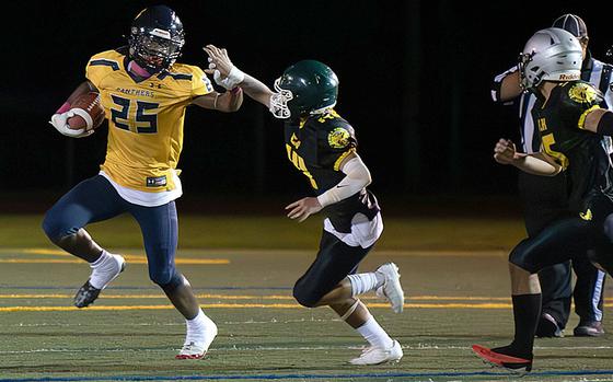 Guam High's Cameron Brantley looks to break free from John F. Kennedy's defense.