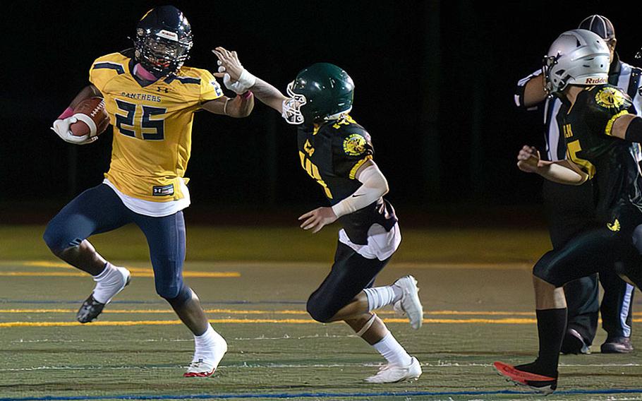 Guam High's Cameron Brantley looks to break free from John F. Kennedy's defense.
