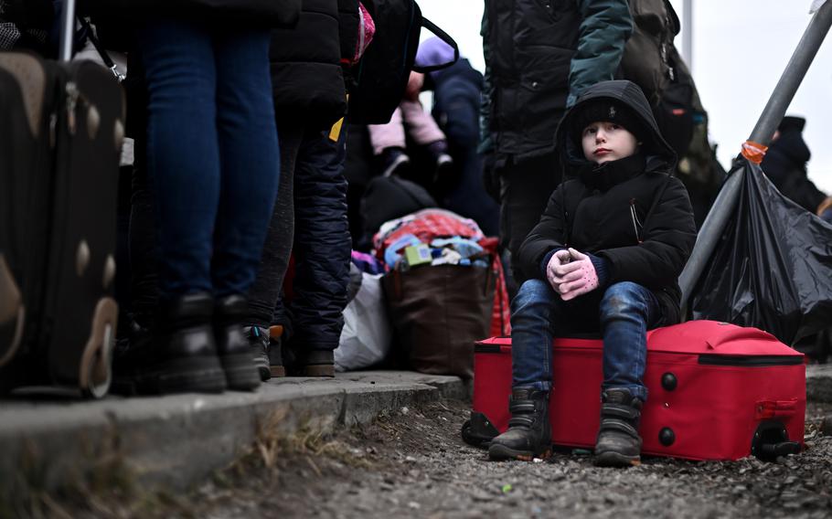 A boy from Ukraine waits to be transported after crossing the border in Medyka, Poland, on March 8, 2022. Health officials fear new outbreaks of COVID-19 and other diseases could be on the horizon as unvaccinated refugees flee into other countries.