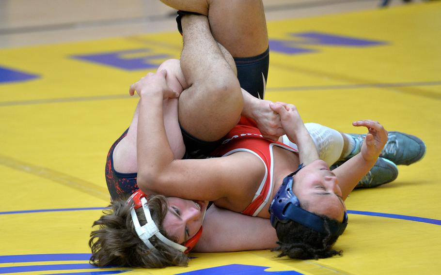 Lakenheath’s Witt Hennig, left, gets a grip on Aviano’s Cruz Cottingham on his way to winning a 190-pound match during the first day of action at the DODEA-Europe wrestling finals in Wiesbaden, Germany, Feb. 10, 2023.