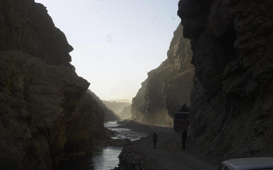 A heavy truck eases its way along a narrow gorge road and the Panjsher Valley that opens into the wide dusty plains toward Kabul. Until recently this area served as the front lines between the Northern Alliance and Taliban.