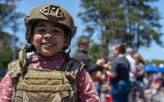 A military child tries on body armor during a Memorial Day event at Misawa Air Base, Japan, May 30, 2022.