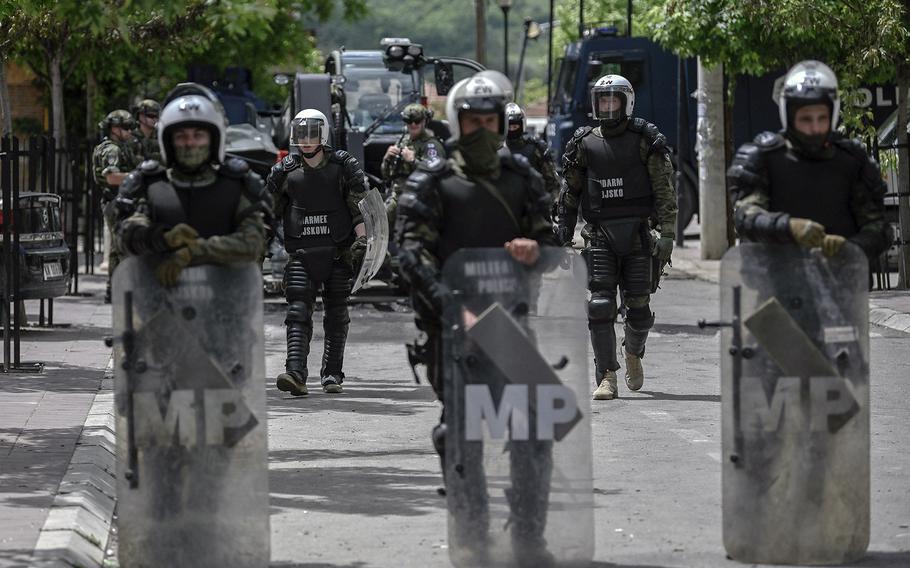 NATO soldiers and International military police secure the area near Zvecan, northern Kosovo on May 30, 2023, a day after clashes with Serb protesters demanding the removal of recently elected Albanian mayors.