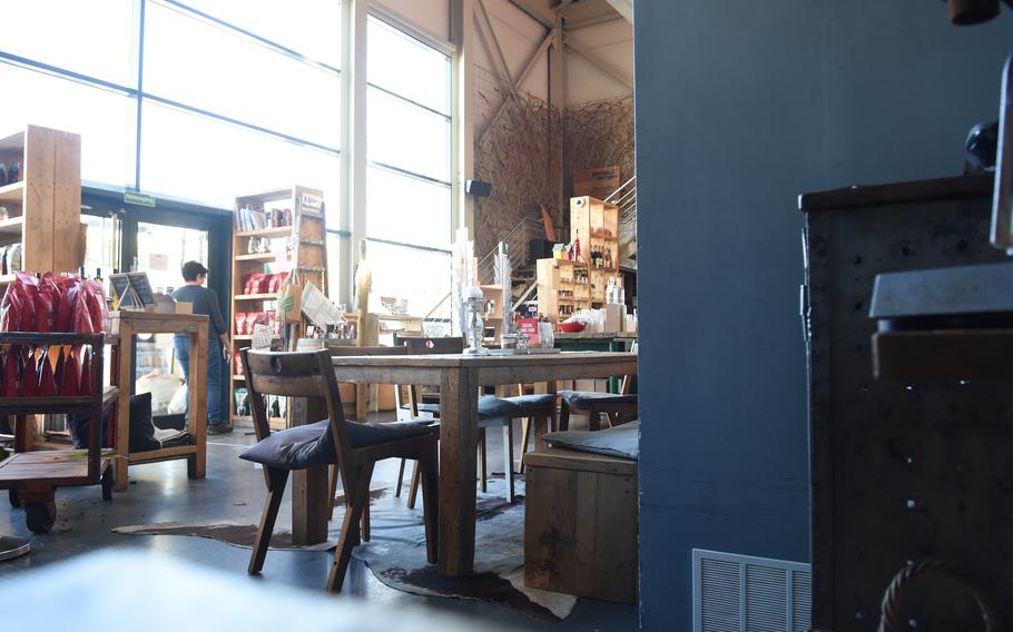 Tall glass windows fronting the store allow for a lot of natural light inside Blank Roast coffee shop in Neustadt, Germany, Nov. 9, 2021. The shop roasts its own coffee beans, which it sells in many varieties. 