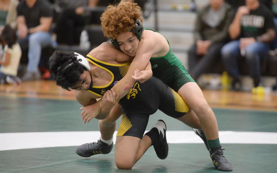Kubasaki 107-pounder Ray Bragdon takes control of Kadena's Jhayden Basto during Wednesday's Okinawa wrestling dual meet. Bragdon won by technical fall 15-4 in 3 minutes, 24 seconds, but the Panthers won the meet 34-28, improving to 4-0 over the Dragons this season.