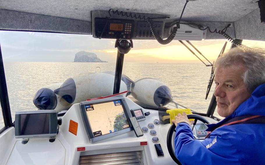 Skipper Alan steers his boat toward the Bass. 