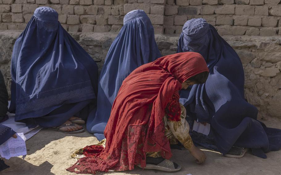 Women wait to see a doctor at a mobile health clinic in Bagrami District, Kabul Province, Afghanistan, on Oct. 31, 2022. 