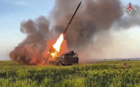 Flames fire out the back of a rocket as it launches.