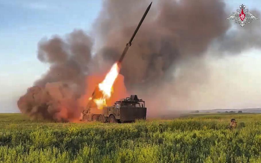 Flames fire out the back of a rocket as it launches.