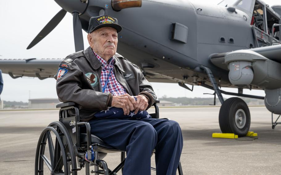 A veteran in a wheelchair sits in front of a Skyraider II.