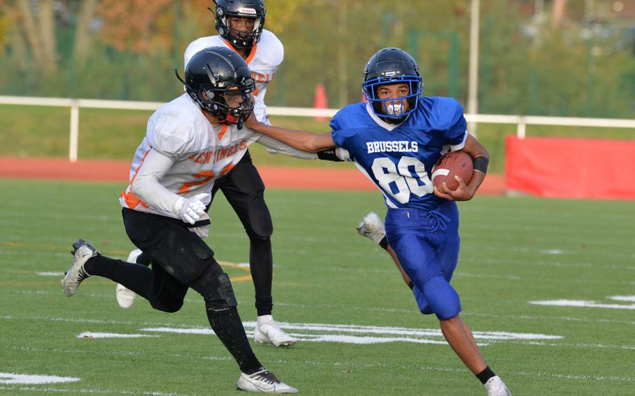 Brussels’ Charles DeMarkus keeps Spangdahlem’s Casey Supinger at a distance on his way to a touchdown in the Brigands’ 64-48 win over Spangdahlem in the DODEA-Europe Division III football final in Kaiserslautern, Germany, Oct. 29, 2022.