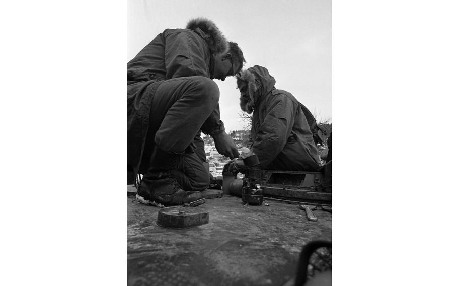 Soldiers battling snow and freezing temperatures take a break to cook up some Meals Ready to Eat. The troops are taking part in the multi-day Carbide Ice exercise, part of Reforger I, in the Grafenwoehr-Vilseck area.