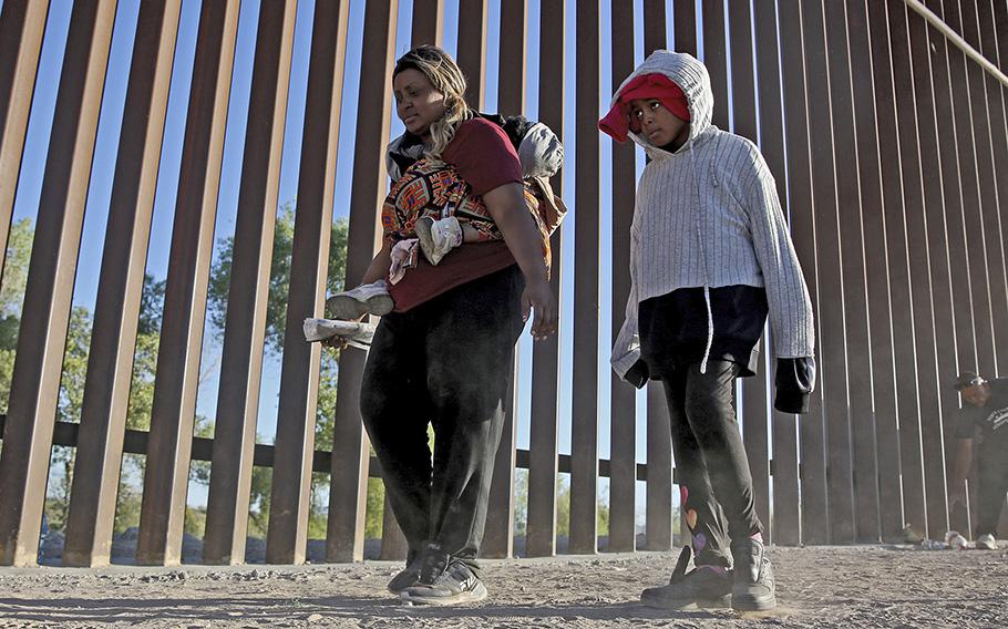 Mary Otaiyi and her children, at the U.S.-Mexico border in Somerton, Arizona, last week, flew from Nigeria to Brazil and took multiple buses in hopes of gaining asylum in the United States. 