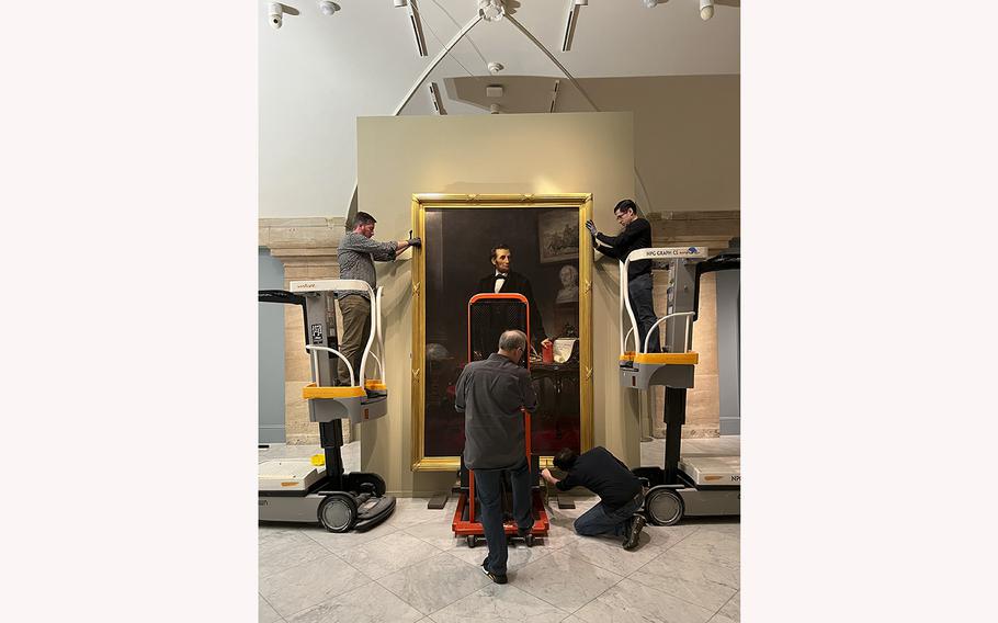 Staff at the Smithsonian’s National Portrait Gallery install an 1865 portrait of Abraham Lincoln by W.F.K. Travers. The painting is on loan to the gallery for five years from the Hartley Dodge Foundation. 