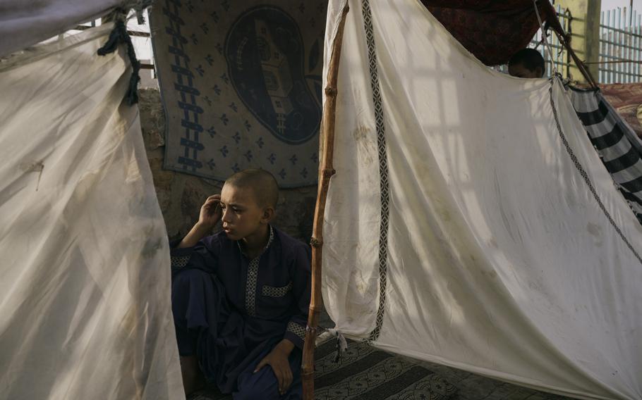 A boy rests in a shelter in Kandahar on July 30, 2021.