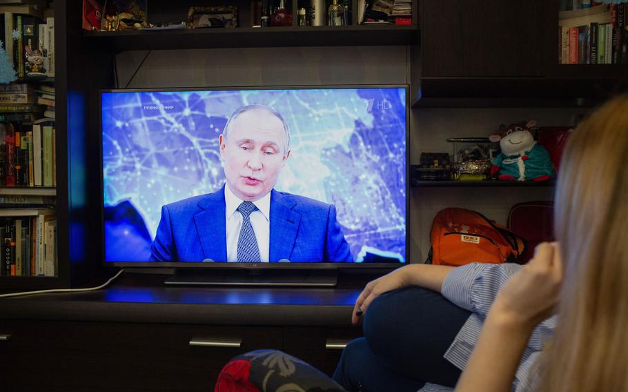 A live broadcast of Russia President Vladimir Putin delivering his annual address on a television in Moscow on Dec. 17, 2020. 