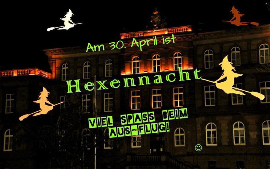 An ominous sign with a spooky house and yellow witches on broomsticks reminds people that April 30 is Witches Night.