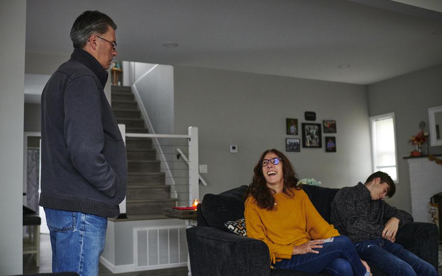 Debi Ganim shares a laugh with her husband, Mike, and their son, Sam, in the family's living room. 