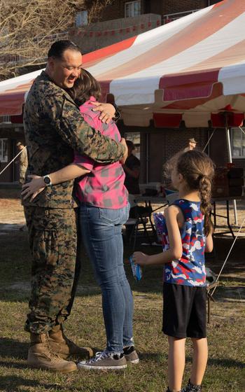 A U.S. Marine with Combat Logistics Battalion 22, 26th Marine Expeditionary Unit (Special Operations Capable) reunites with his family at Camp Lejeune, N.C., Monday, March 18, 2024.