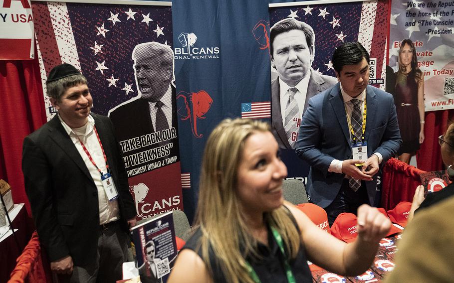 Posters of former president Donald Trump and Florida Gov. Ron DeSantis are displayed during the first day of the CPAC conference in Orlando on Feb. 24, 2022.