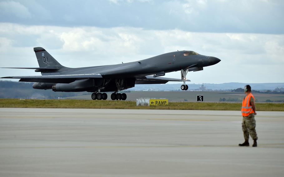 An airman watches as a B-1B Lancer lands at Spangdahlem Air Base, Germany, Oct. 11, 2021. A pair of Bones, from the 9th Expeditionary Bomb Squadron, Dyess Air Force Base, Texas, refueled at the base following a mission over Lithuania.