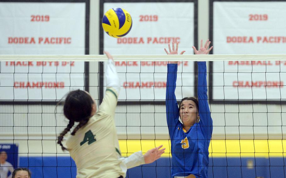 Robert D. Edgren's Milan Bean goes up to spike against Yokota's Erica Haas during Saturday's DODEA-Japan girls volleyball match. The Panthers won in three sets Saturday and four sets Friday.