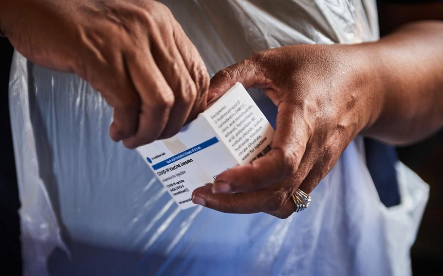 A health worker opens a box containing vials of the Johnson & Johnson COVID-19 vaccine during a rural vaccination drive at Duduzile Secondary School in Mpumalanga, South Africa, on March 9, 2022.