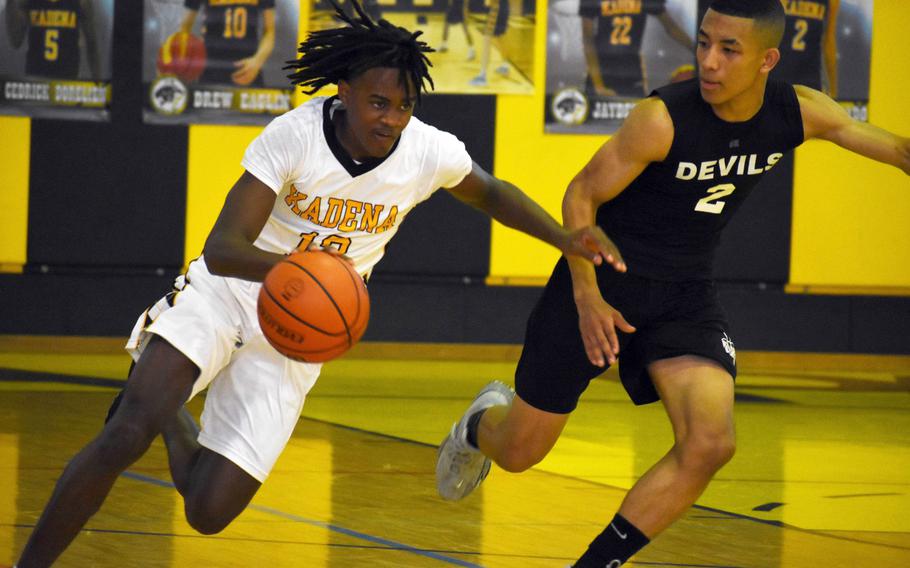 Kadena's Deshaun Nixon dribbles upcourt against Nile C. Kinnick's Vance Lewis. The Panthers won 64-62.