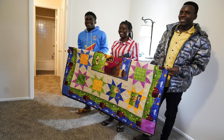 Refugees from Congo — from left, Sadock Ekyochi, his wife Riziki Kashindi and her brother Kaaskile Kashindi — pose for a photo inside their new apartment, Thursday, April 11, 2024, in Columbia, S.C. The American refugee program, which long served as a haven for people fleeing violence around the world, is rebounding from years of dwindling arrivals under former President Donald Trump. The Biden administration has worked to restaff refugee resettlement agencies and streamline the process of vetting and placing people in America.
