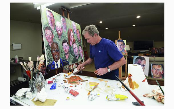 This photo provided by the George W. Bush Presidential Center shows former President George W. Bush working on a portrait of service members and veterans.  The George W. Bush Institute is loaning the 60 color portraits by the former U.S. president to Walt Disney World.  The paintings of service members and veterans will be on display for a year starting next month at Epcot's American Adventure pavilion. (Courtesy of the George W. Bush Presidential Center via AP)