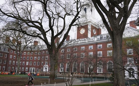 A student walks through the courtyard outside Eliot House at Harvard University, Tuesday, April 15, 2025, in Cambridge, Mass. (AP Photo/Charles Krupa)