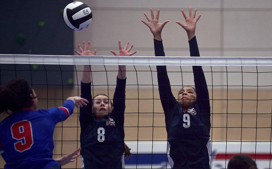 Lakenheath's Ashley Christensen, center left, and A'Lydia McNeal go up to block a spike by Ramstein's Sophia Schluth during pool-play action of the DODEA European volleyball championships on Oct. 26, 2023, at Ramstein High on Ramstein Air Base, Germany.