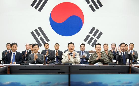 South Korean Defense Minister Shin Won-sik, center, and other military officials watch from Seoul as the country's second spy satellite is launched on April 8, 2024.