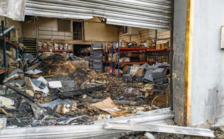 The interior of a warehouse is seen strewn with wreckage.