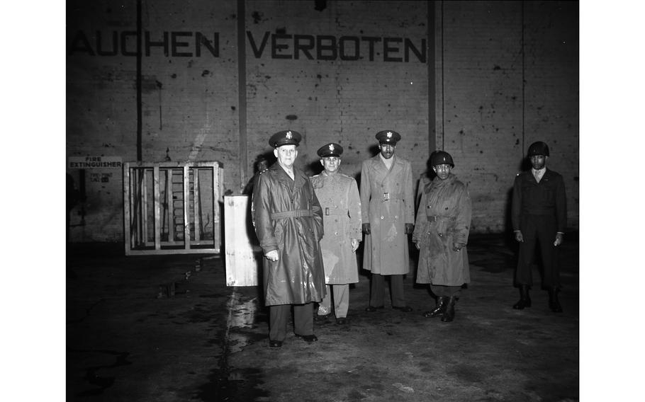 Lt. Gen. Clarence R. Huebner (left) tours the Kitzingen Basic Training Center for Negro troops, accompanied by Brig. Gen. Lewis C. Beebe (second from left), commandant of the center, and Lt. Col. Marcus Ray, EUCOM adviser on Negro affairs (next to Beebe).