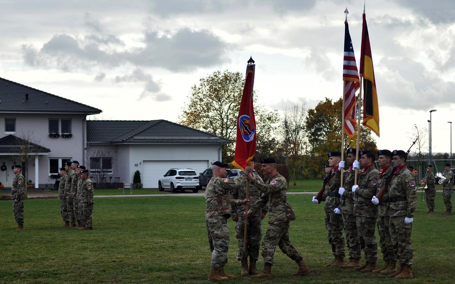 Command Sgt. Maj. Darrell Wall of the 56th Artillery Command hands the unit's flag to Gen. Christopher Cavoli, commander of U.S. Army Europe and Africa, during the artillery unit's reactivation ceremony, Nov. 8, 2021, in Wiesbaden, Germany. 