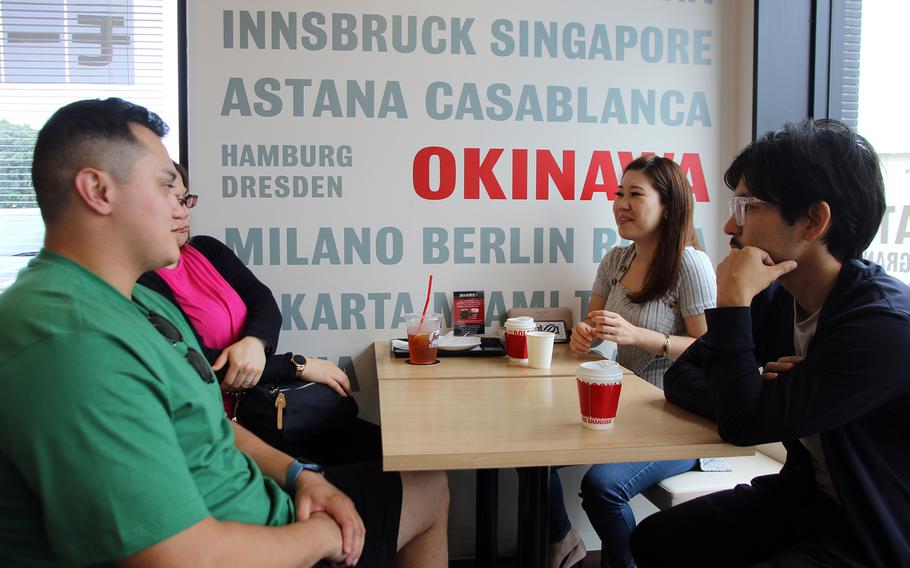 Members of the U.S. Army's 10th Support Group at Torii Station chat with their Japanese neighbors at the Segafredo coffee shop in Yomitan, Okinawa, Tuesday, June 20, 2023.