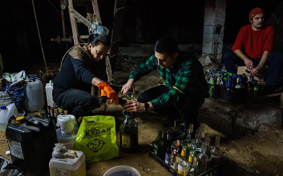 Volunteers from the Territorial Defense Units make Molotov cocktails to use against the invading Russian troops in Kyiv, Ukraine, Saturday, Feb. 26, 2022. 