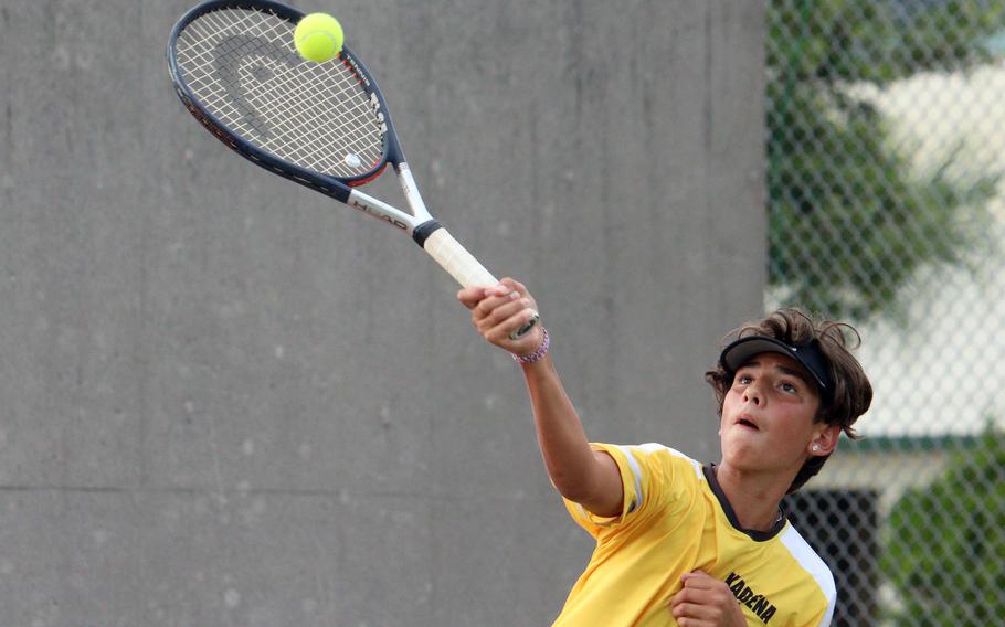 Kadena's Marco Leone hits an overhead smash during Wednesday's Okinawa tennis mixed doubles matches. Leone and partner Celeste Pallares beat Kubasaki's Aidan Shaver and Victoria Lawrence 8-4.